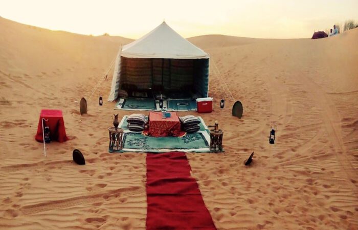 Sunrise over the Arabian Desert with a luxurious 4x4 vehicle on a desert safari adventure. Sunrise Desert Safari